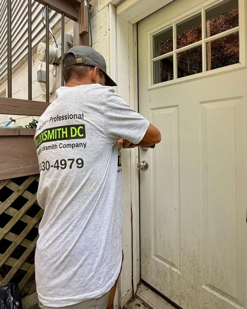Mr. Locksmith DC technician working on the lock of a white exterior door